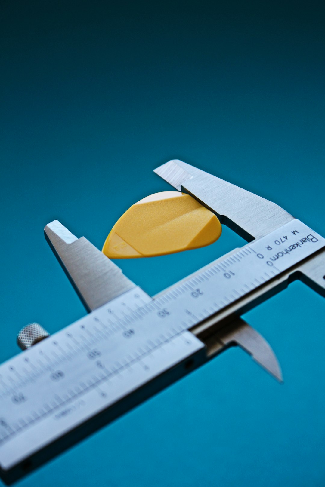 yellow and white sliced lemon precision measuring tools micrometer caliper machined part
