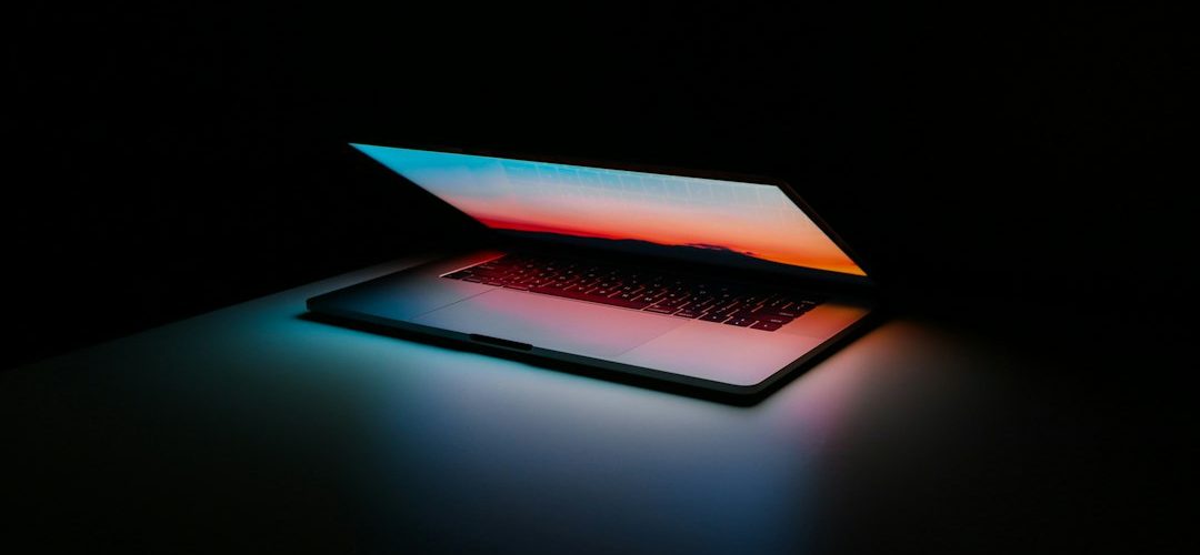 gray and black laptop computer on surface laptop screen patches colored blocks display defect