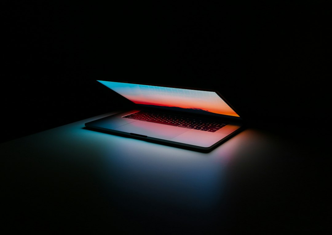 gray and black laptop computer on surface laptop screen patches colored blocks display defect