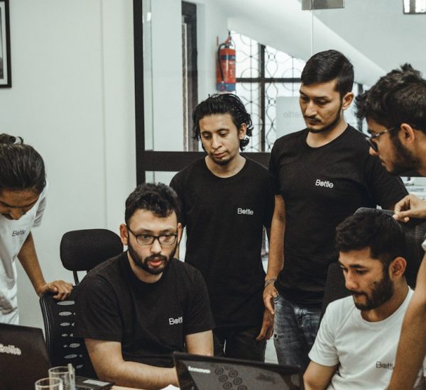 How to Use Feature Flags in SaaS Applications to Release New Features Safely and Improve Product Development 9 people near a black top computer in a room startup workflow prototype handoff product team