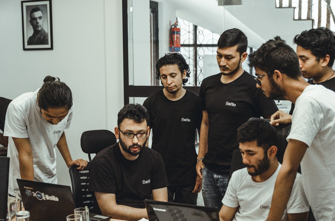 people near a black top computer in a room startup workflow prototype handoff product team