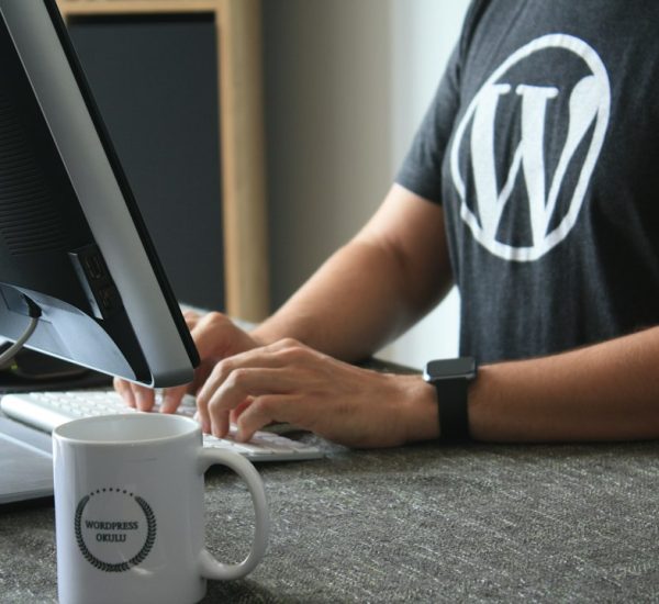 person in black and white t shirt using computer wordpress maintenance page hosting migration website downtime