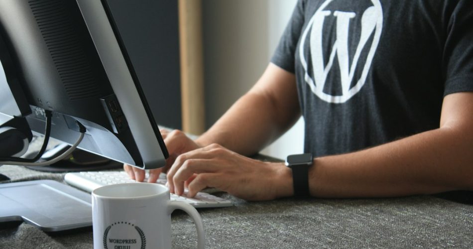 person in black and white t shirt using computer wordpress maintenance page hosting migration website downtime