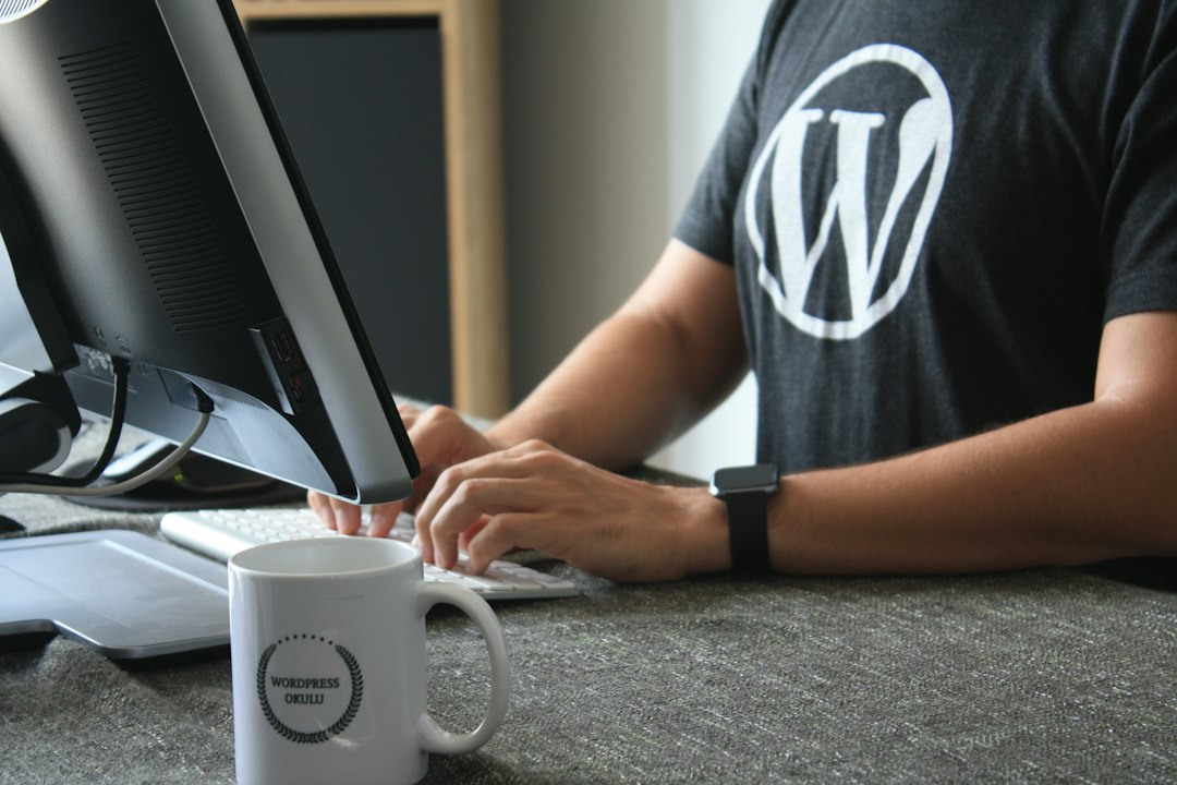 person in black and white t shirt using computer wordpress maintenance page hosting migration website downtime