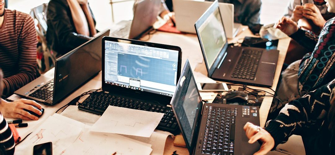 person using black laptop computer public relations team media database campaign planning