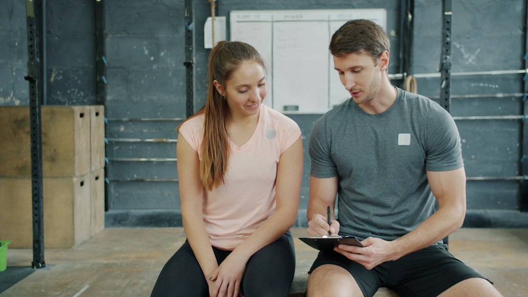 trainer and client discussing workout plan in gym fitness coach video post engagement chart