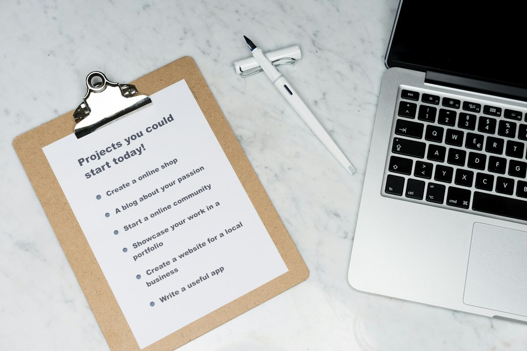 white printer paper beside silver laptop computer email checklist professional farewell workplace etiquette